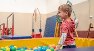 Small boy looks happy in the ball pit at Seaford Kindergym